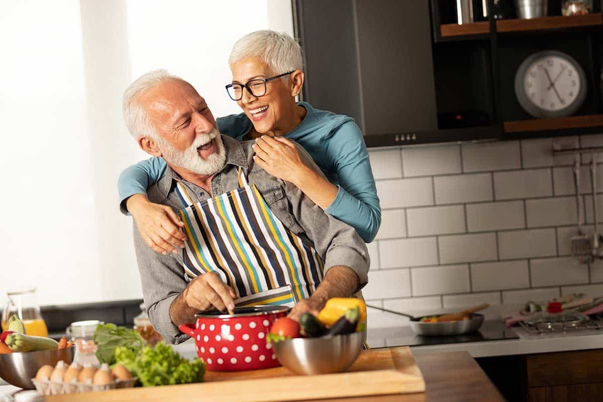 Elderly couple cooking together, highlighting the importance of nutrition for bone health